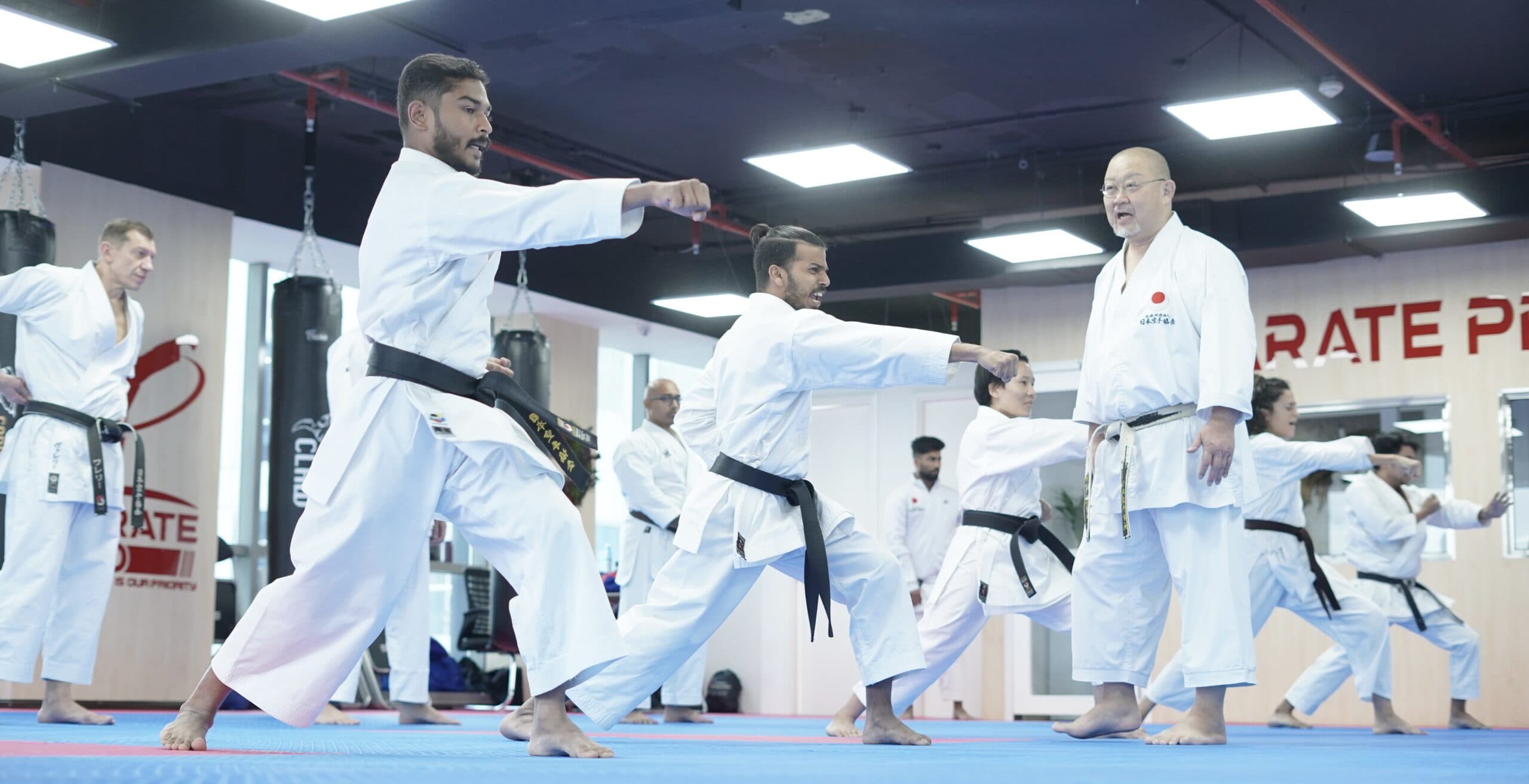 Adult students performing kata together during a class at Karate Pro Academy