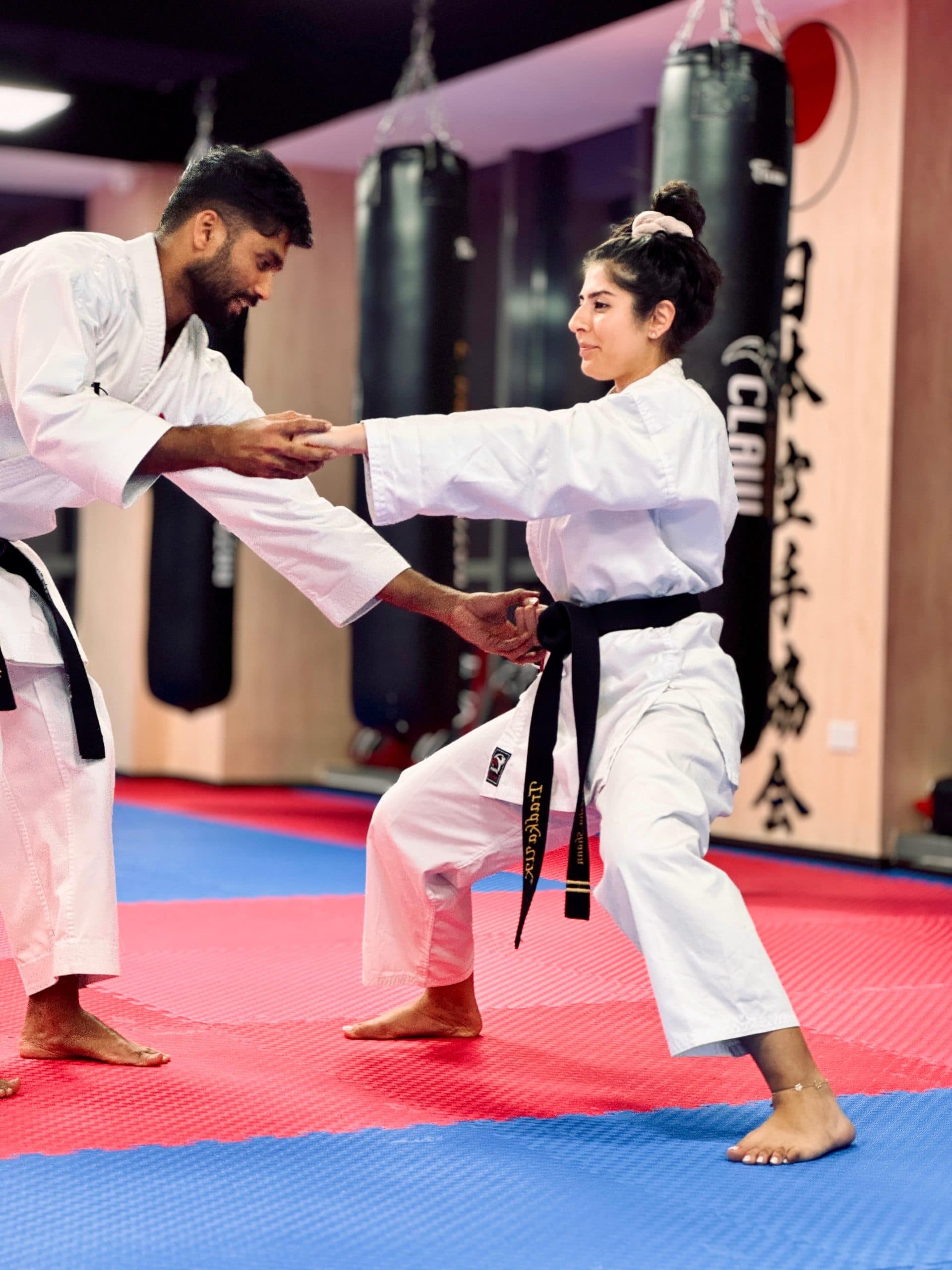 An instructor coaching a student one-to-one in a private karate session