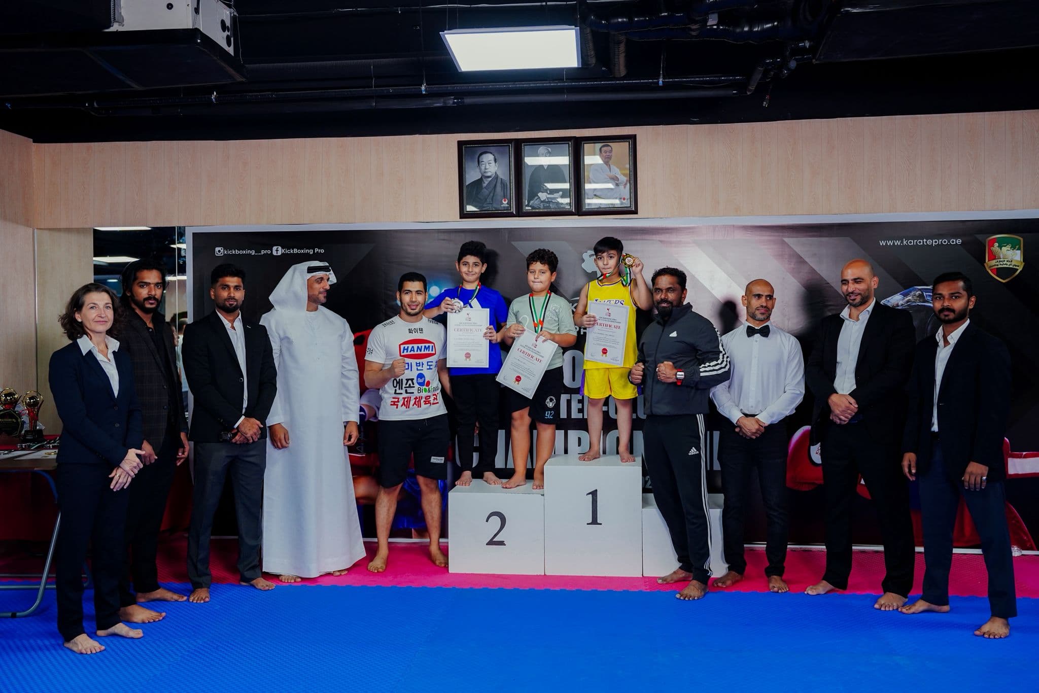 Young kickboxers on the podium with medals and certificates at the inter club championship 2025