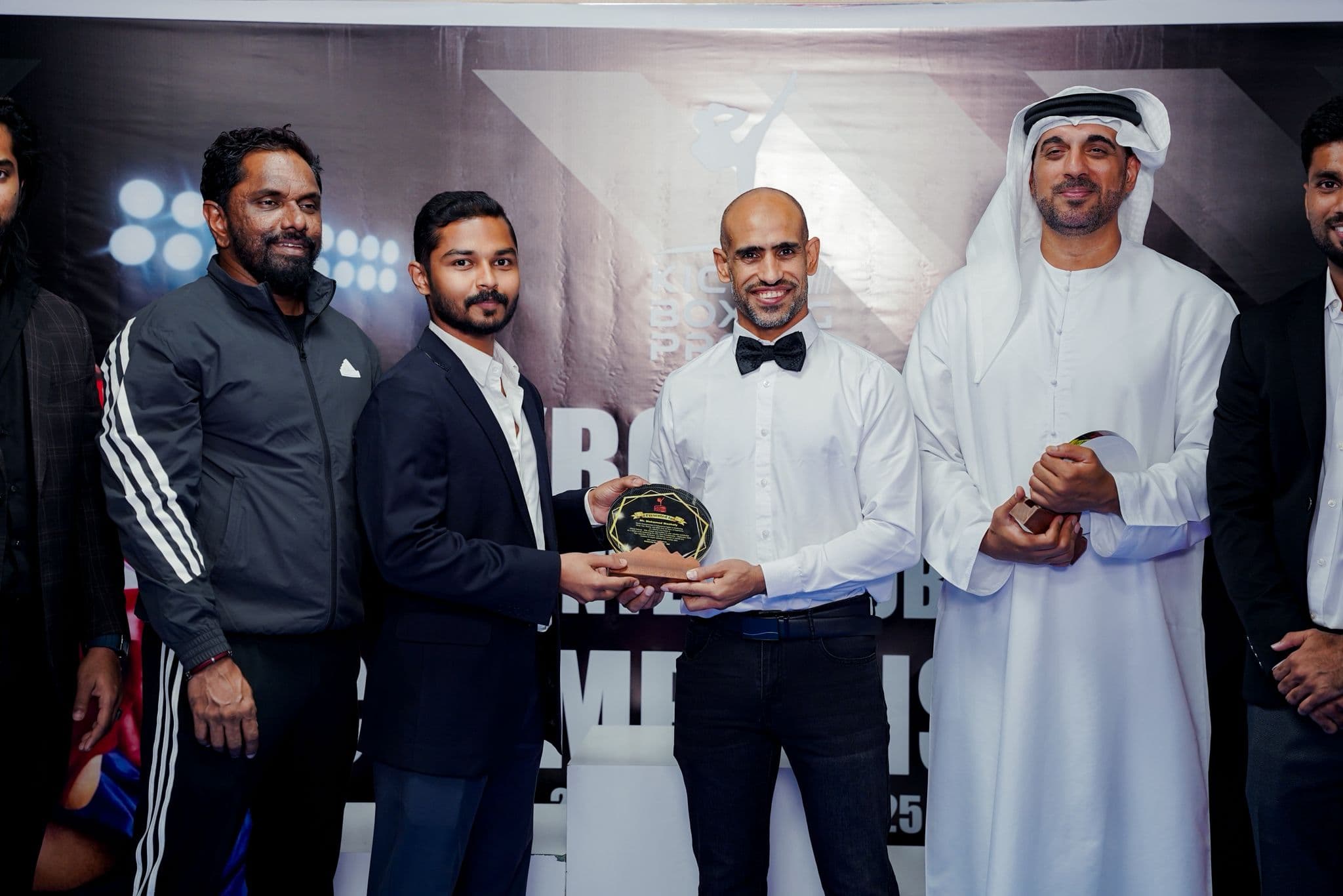 Dignitaries presenting an award plaque to an organiser at the Kickboxing pro inter club championship 2025