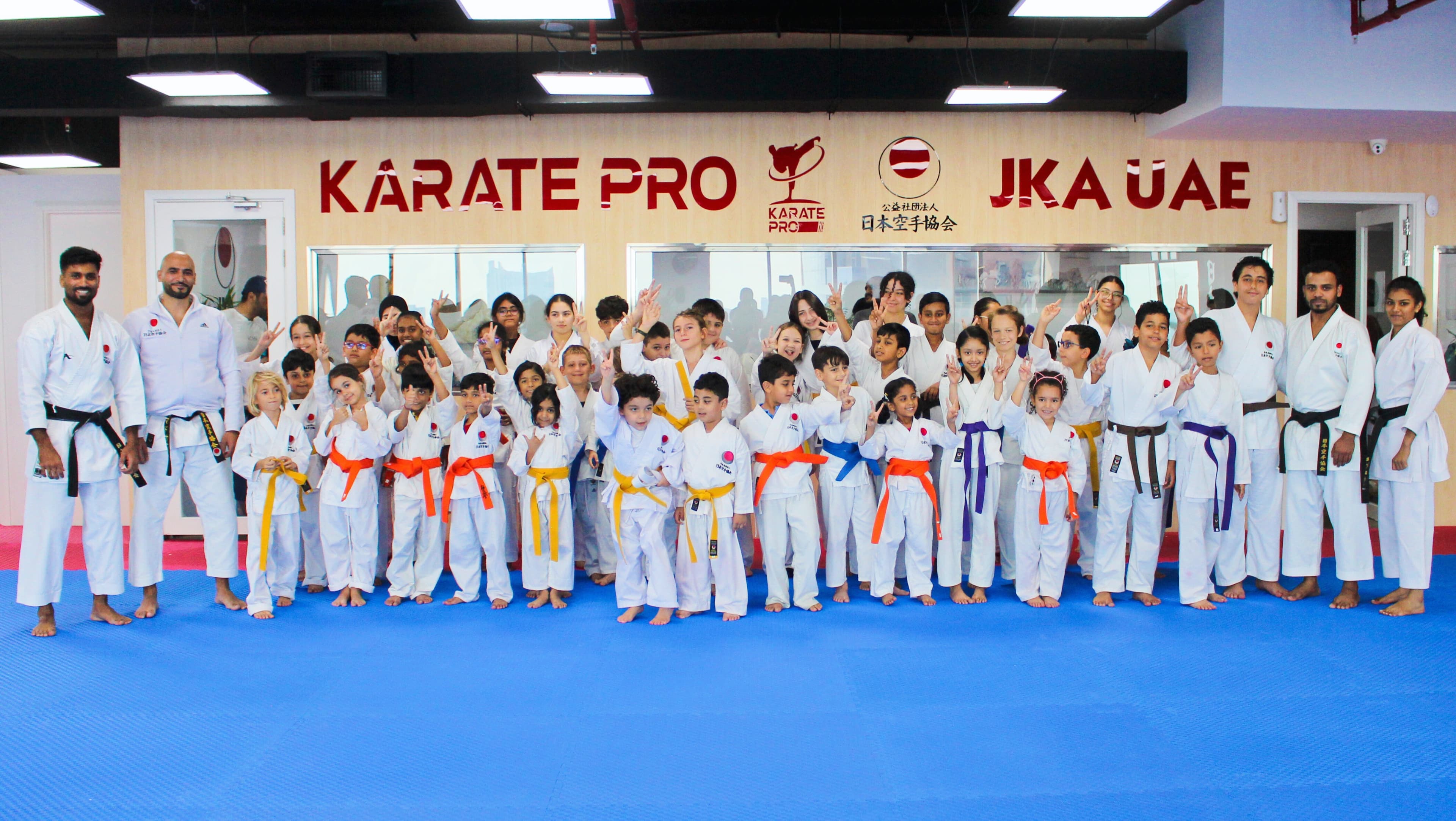 Karate Pro Academy students and instructors gathered together for a group photo in white gi