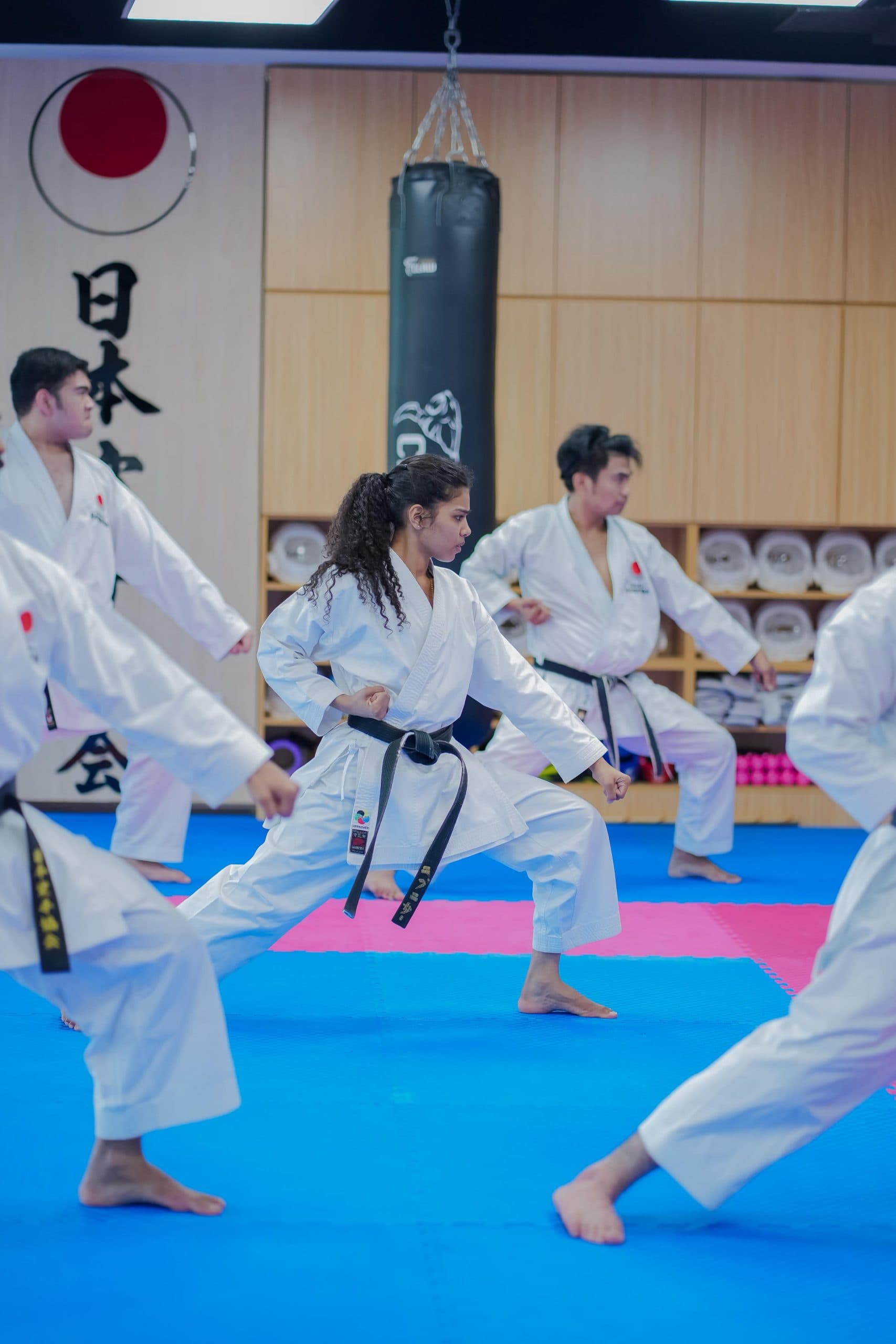 Adult students performing a kata stance during class