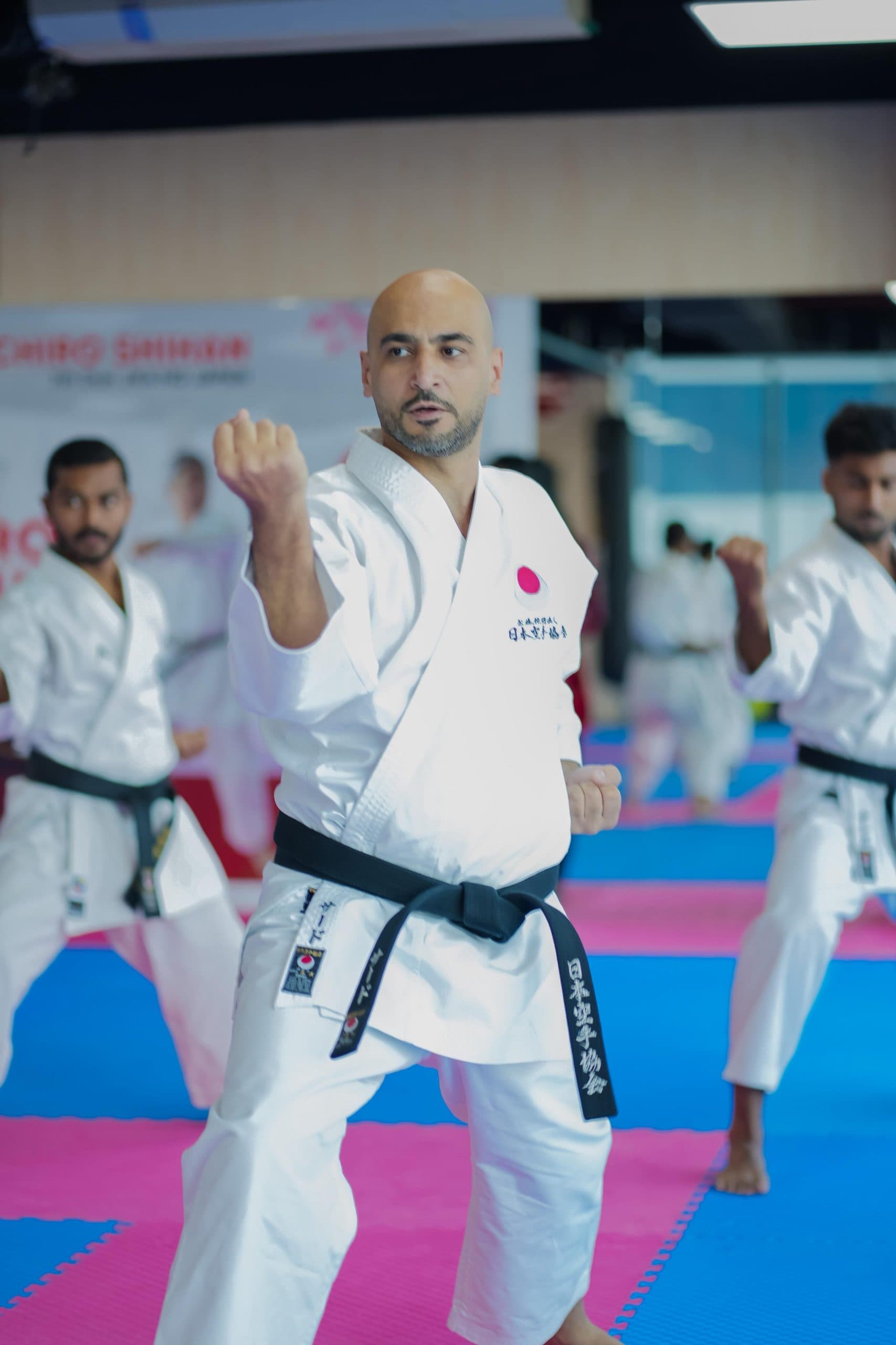 Adult black belt holding a kata stance