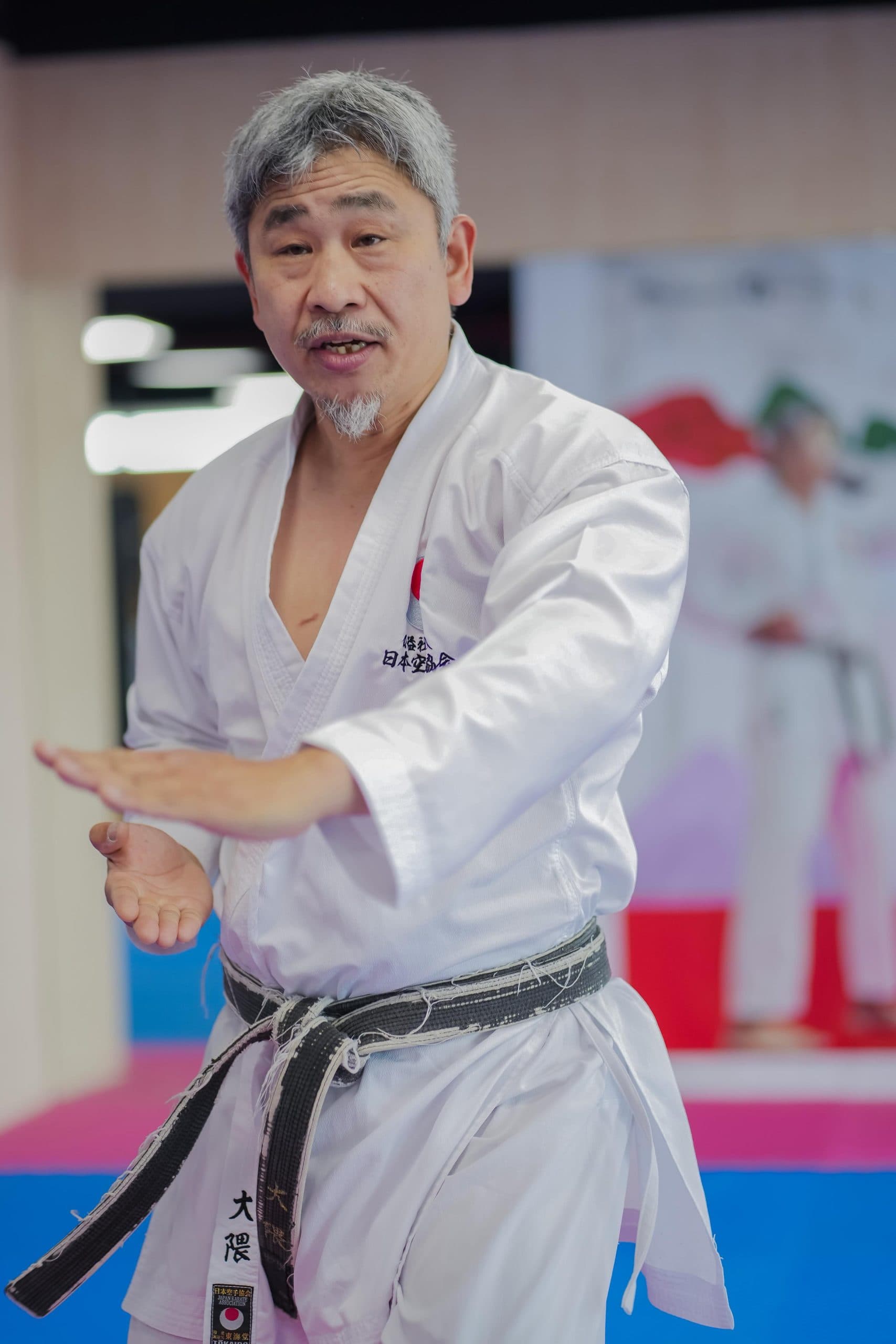 Senior JKA instructor demonstrating a hand technique in the dojo