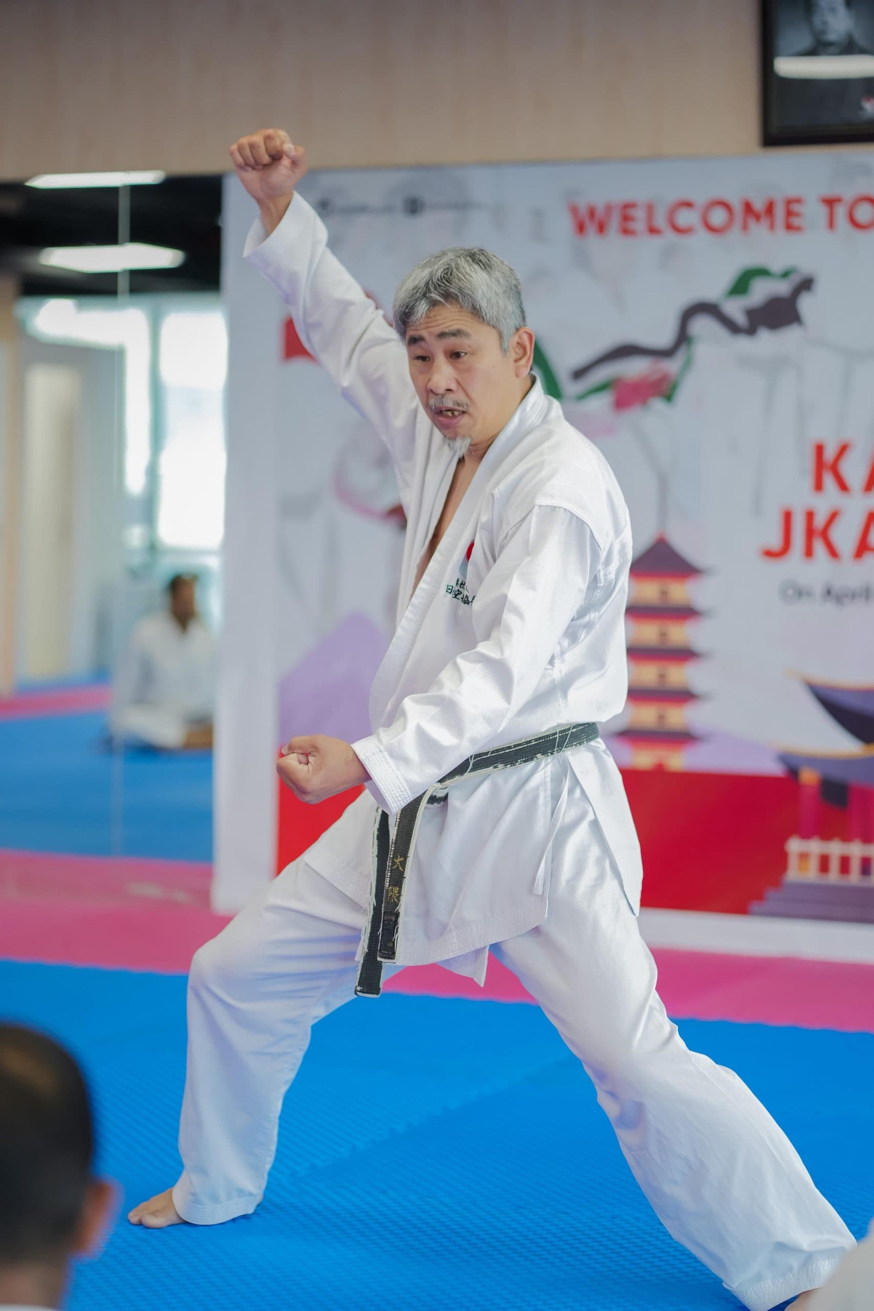 Instructor guiding adult students through a kata drill