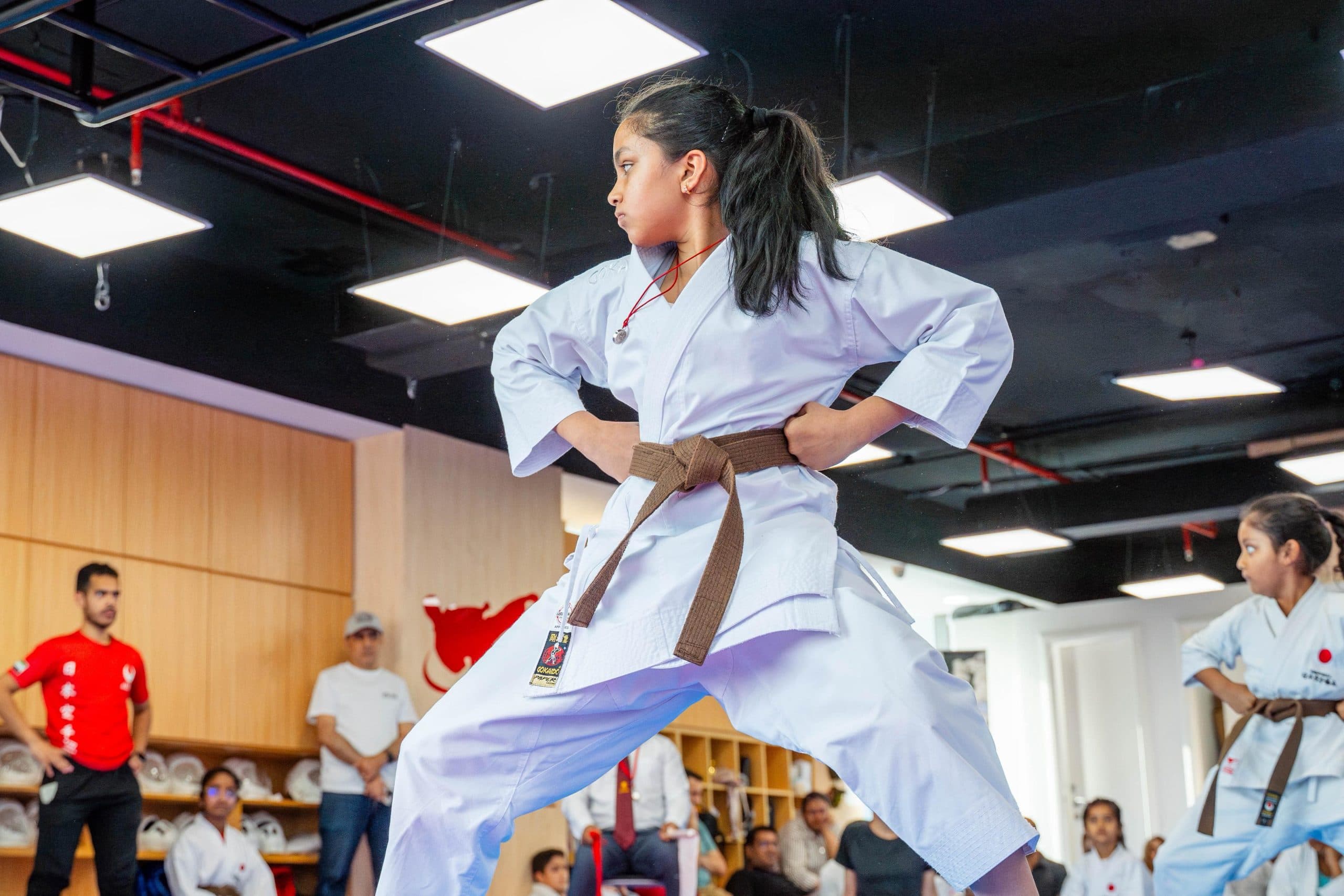 Young girl holding a kata stance during a kids karate class