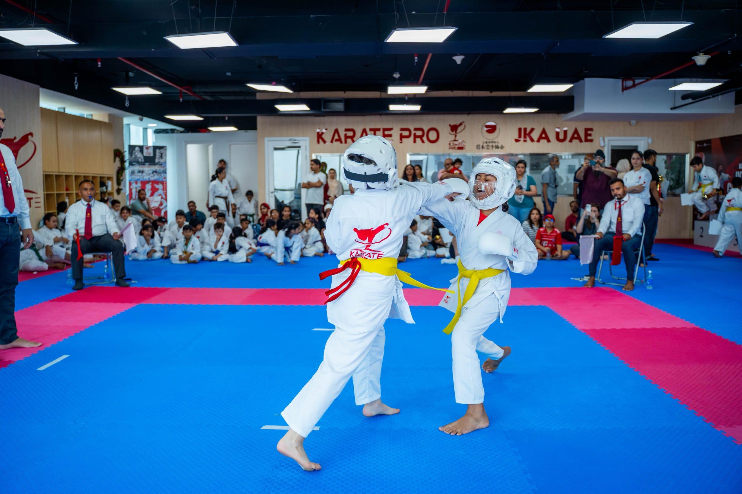 Two young students sparring during a kids karate kumite drill