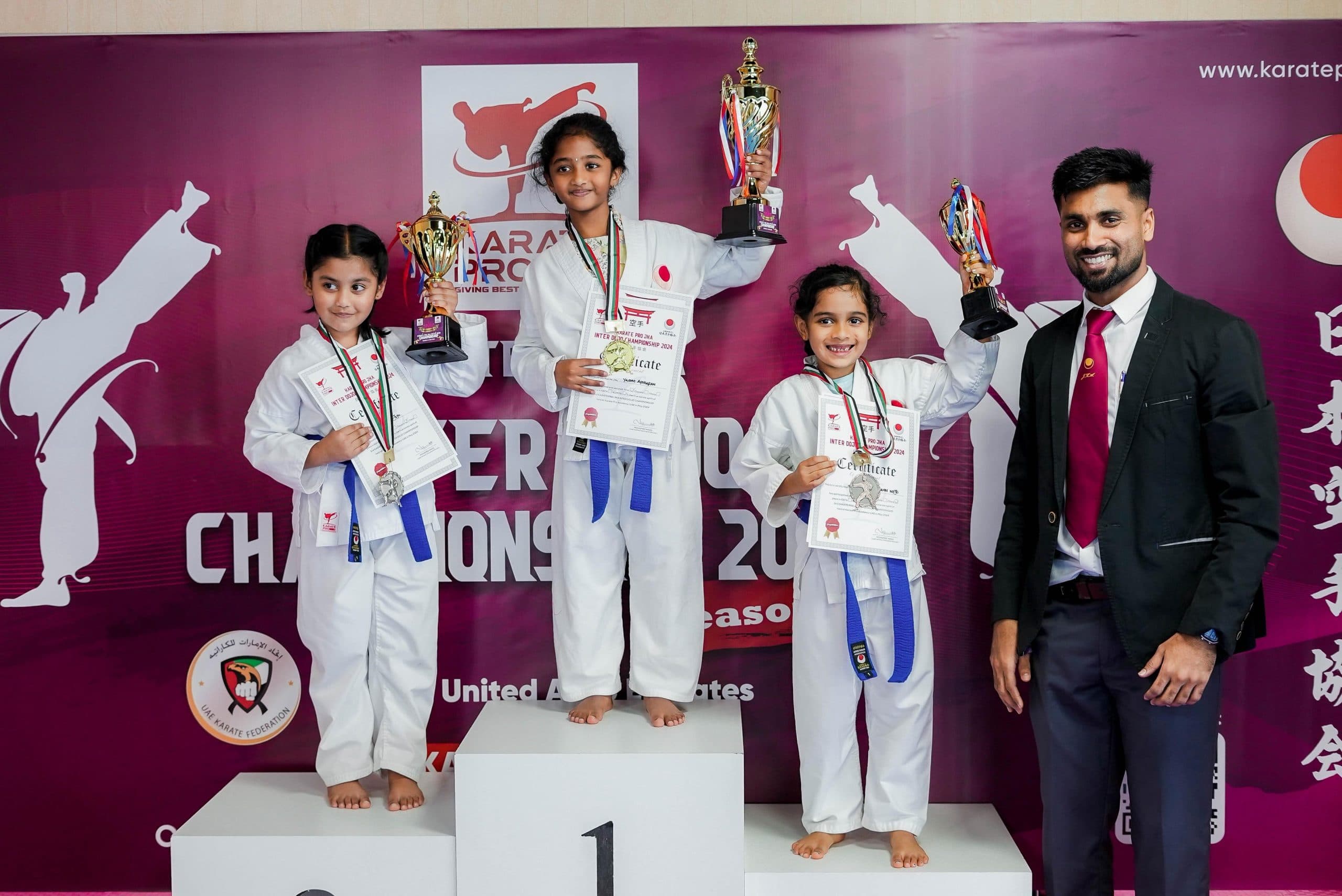 Young karate students on the podium with medals