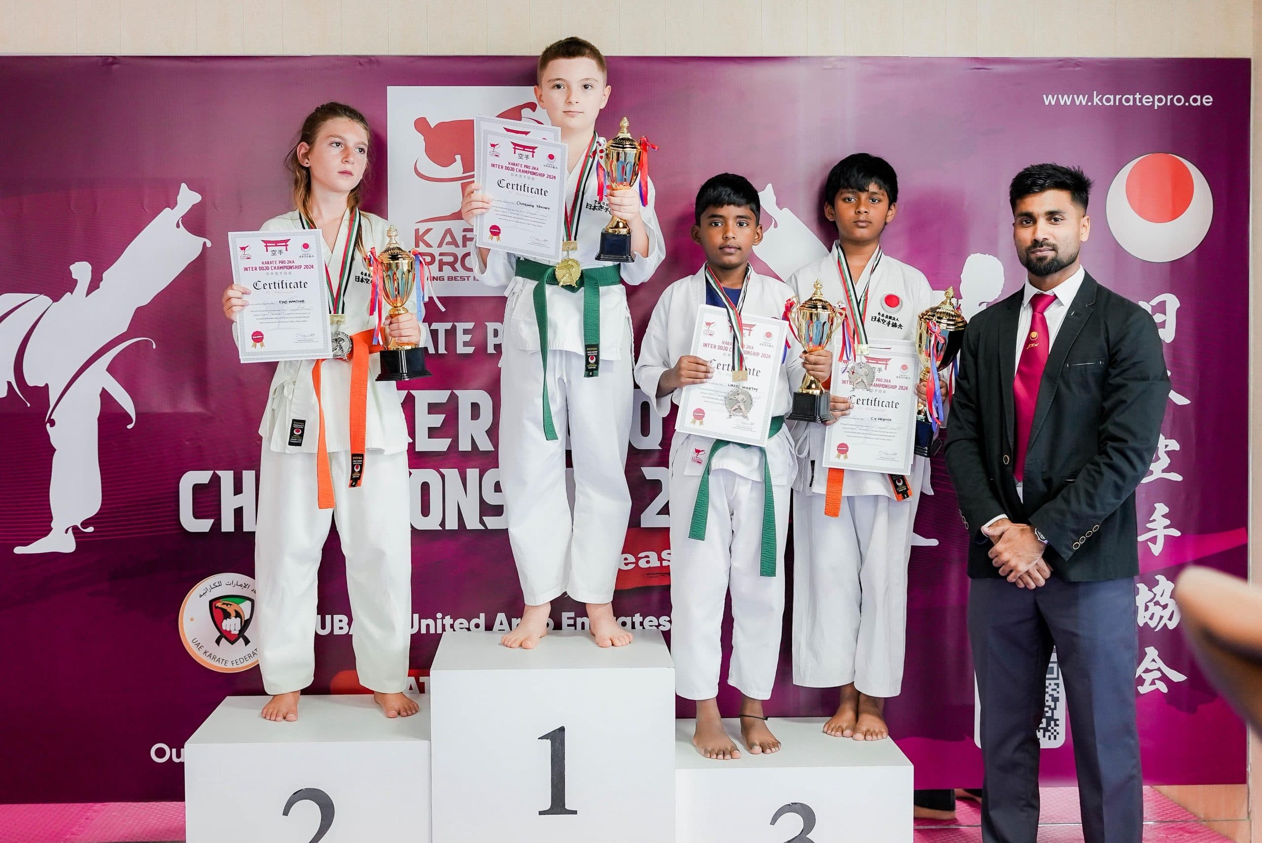 Kids karate medallists posing with their awards