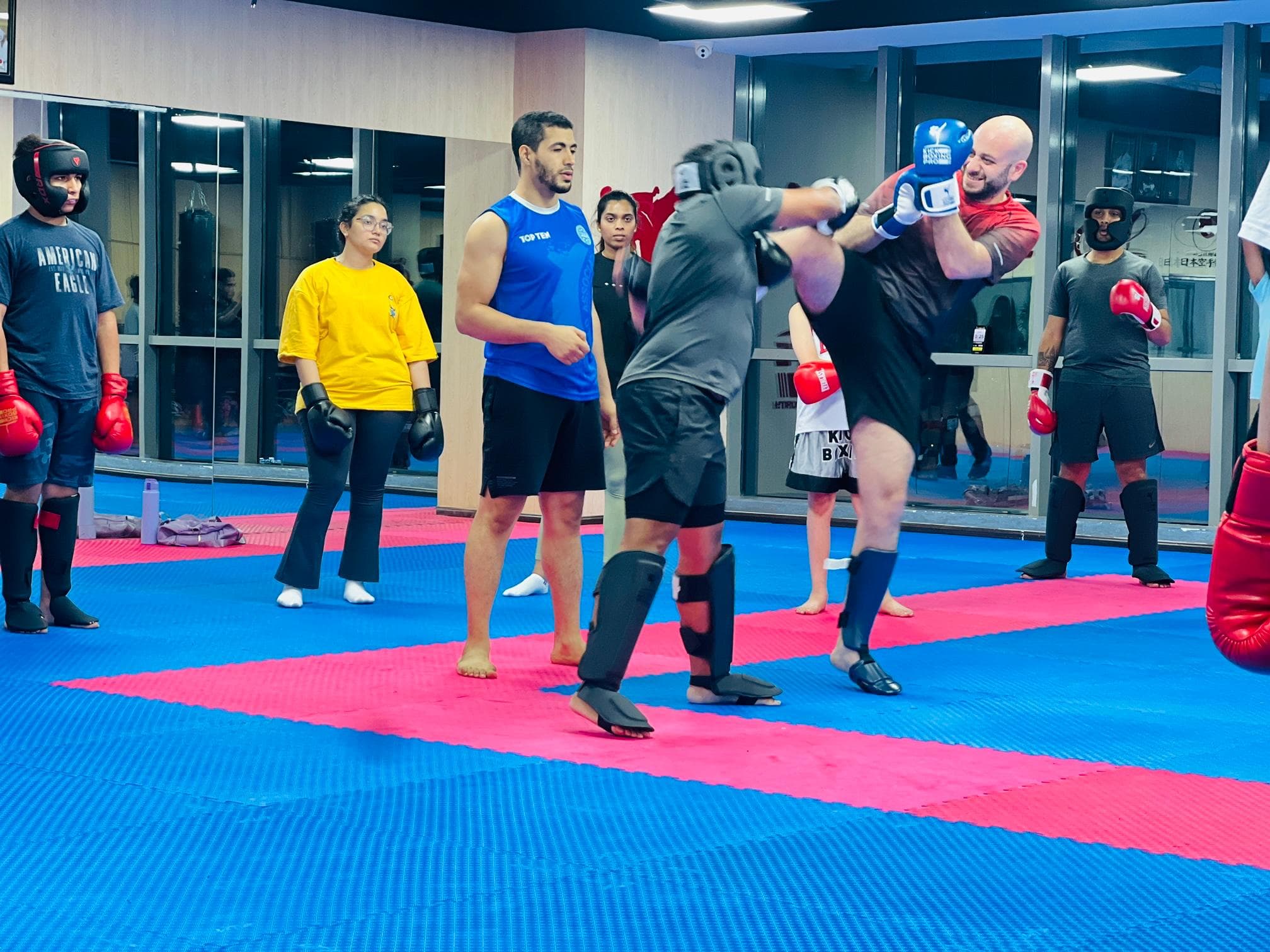 Adult kickboxing class working through a technique drill