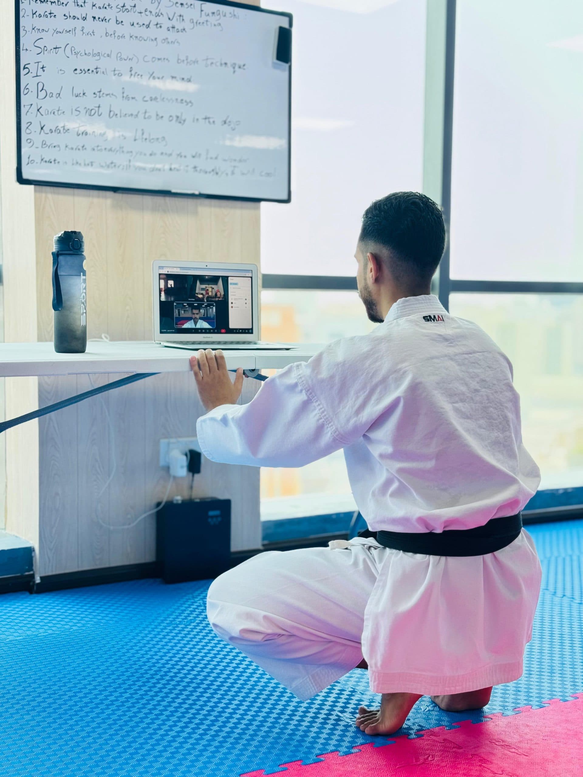 Instructor demonstrating technique during an online karate session