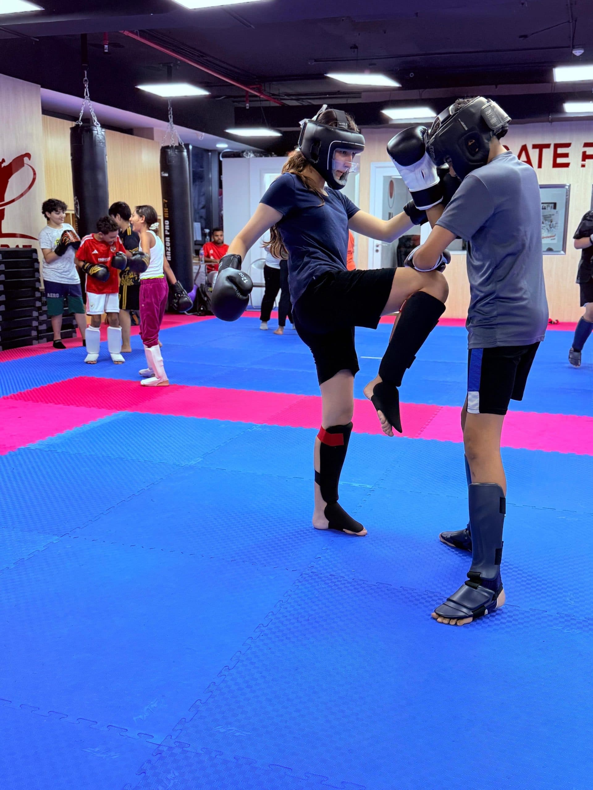 Teenager practising a kicking drill during class